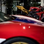 Red motorcycle and car on display