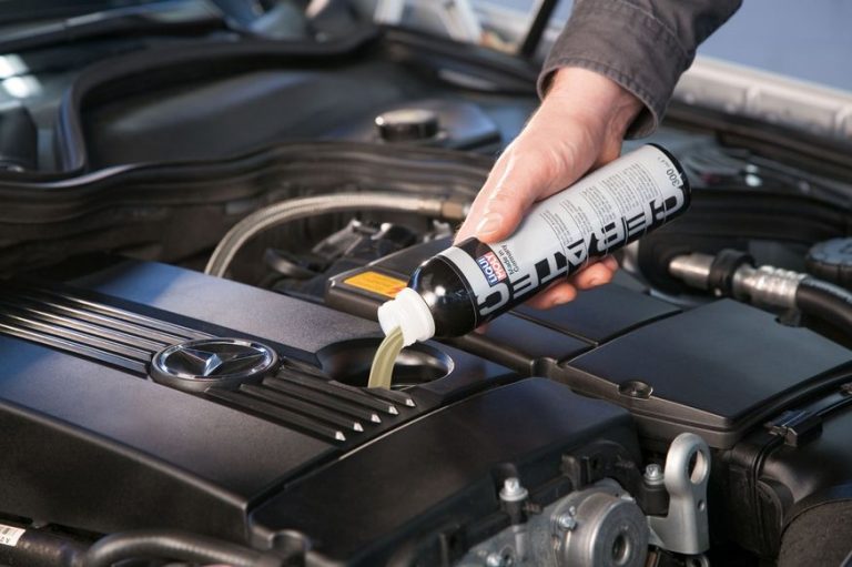 Man pouring Liqui Moly Cera Tec product in car engine