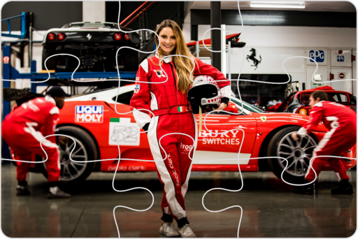 Puzzle pieces of female race car driver in red suit
